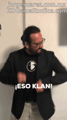 Man In Black Jacket And Face Shirt Says Eso Klan GIF