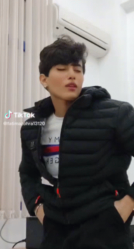 Man in Black Jacket and Tommy Hilfiger Shirt by Air Conditioner