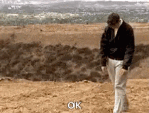 Man in Black Jacket and White Pants Saying Ok
