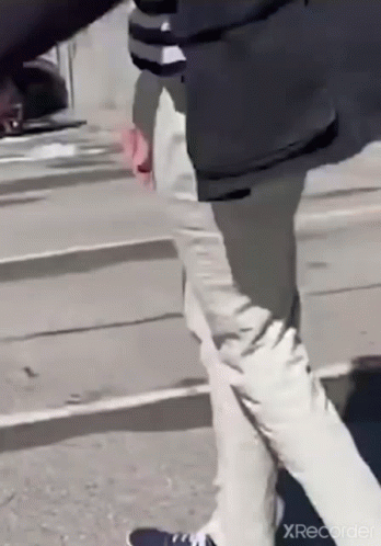 Man in Black Jacket and White Pants Walking