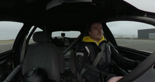 Man in Black Jacket and Yellow Hoodie Driving