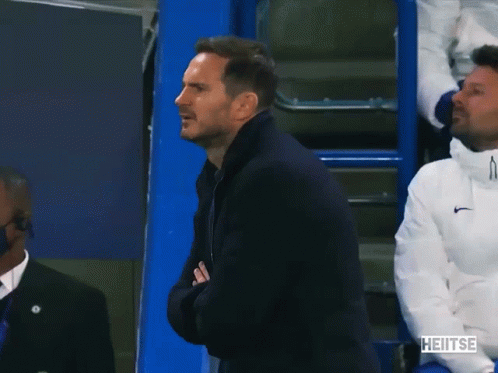 Man In Black Jacket Applauds In Front Of Blue Cooler Saying Heitse GIF