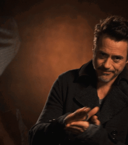 Man in Black Jacket Clapping Hands
