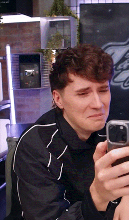 Man in Black Jacket Crying With Cell Phone
