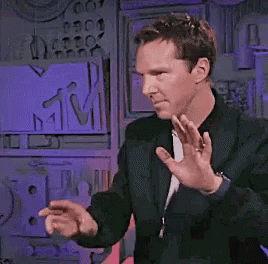 Man in Black Jacket Dancing in Front of MTV Sign
