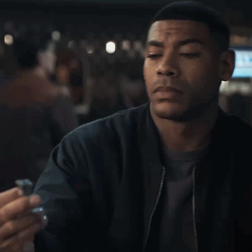Man In Black Jacket Eyes Closed Holding Something GIF