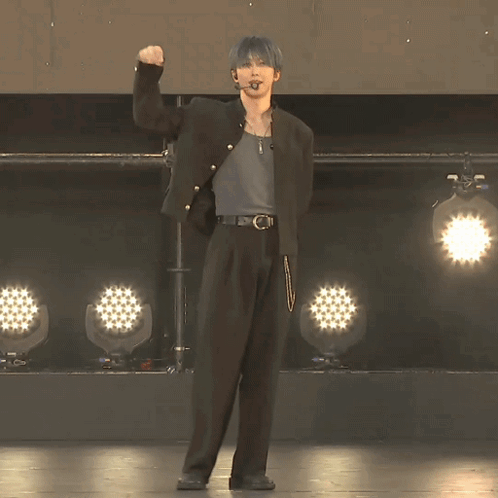 Man In Black Jacket Facing Row Of Lights GIF