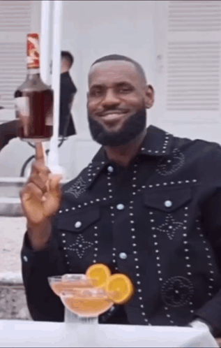 Man In Black Jacket Holding Bottle Of Alcohol GIF