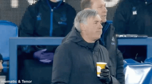Man in Black Jacket Holding Coffee