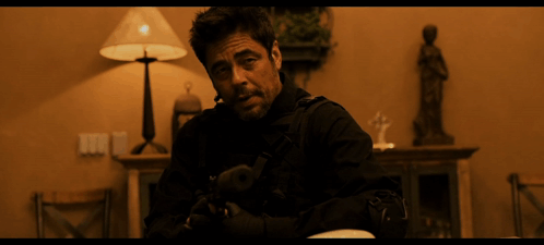 Man in Black Jacket Holding Gun in Dark Room