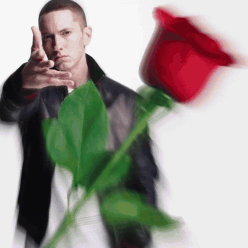 Man in Black Jacket Holding Large Red Rose