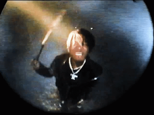 Man in Black Jacket Holding Torch Dark Room