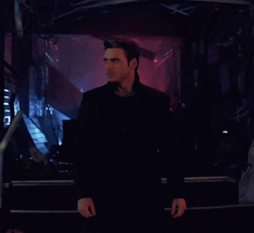 Man In Black Jacket In Front Of Screen GIF