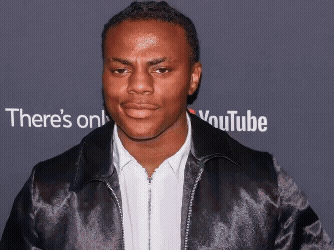 Man In Black Jacket In Front Of YouTube Sign GIF