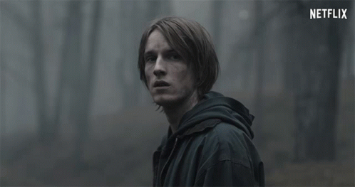 Man in Black Jacket Looking at Netflix Logo