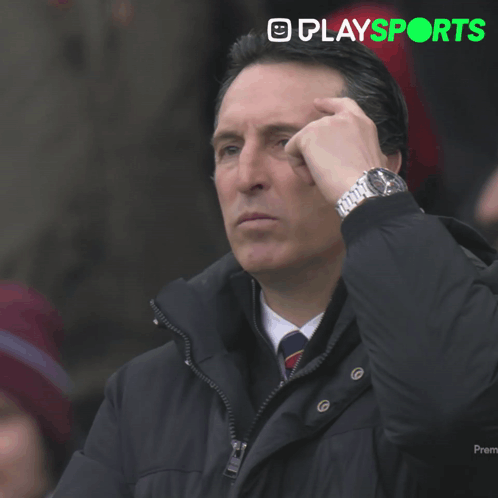 Man in Black Jacket Looking at Watch With Playsports Logo