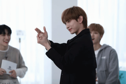 Man In Black Jacket Making Heart With Fingers GIF