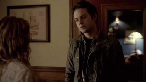 Man in Black Jacket Next to Woman in Room