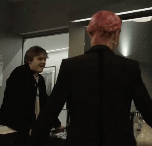 Man in Black Jacket Next to Woman With Pink Hair
