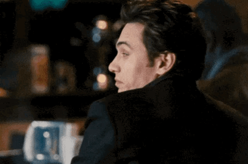 Man in Black Jacket Sitting at Table