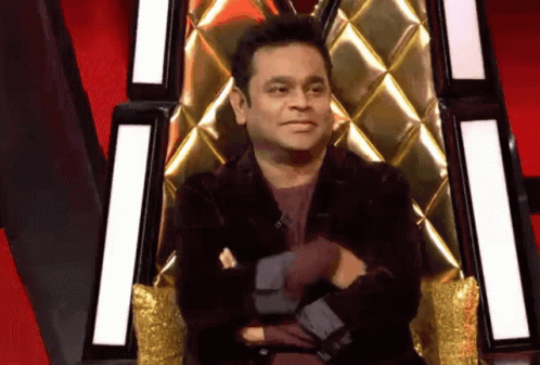 Man in Black Jacket Sitting Crossed Arms