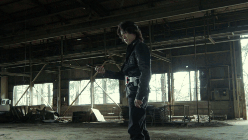 Man in Black Jacket Standing in Empty Room