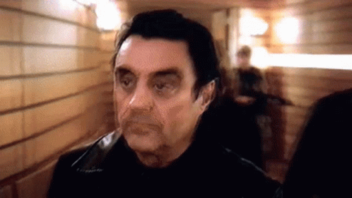 Man in Black Jacket Standing in Hallway