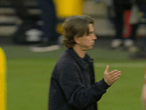 Man in Black Jacket Standing on Field
