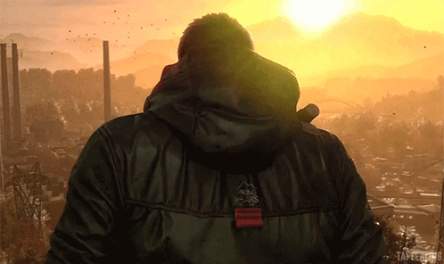 Man in Black Jacket With Peaks at Sunset