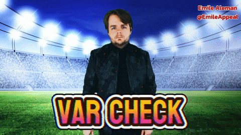 Man in Black Jacket with Var Check at Stadium