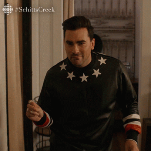 Man In Black Jacket With White Stars Pointing GIF
