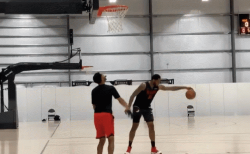 Man in Black Jersey Number 8 Dribbling Basketball