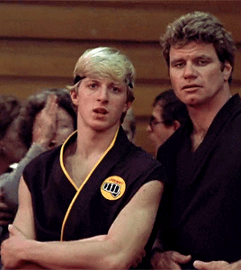 Man In Black Karate Uniform With Yellow Karate Patch GIF