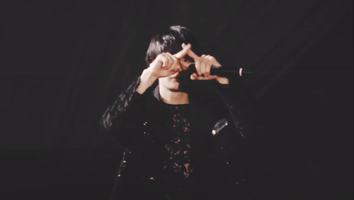 Man in Black Lace Top Holding Microphone
