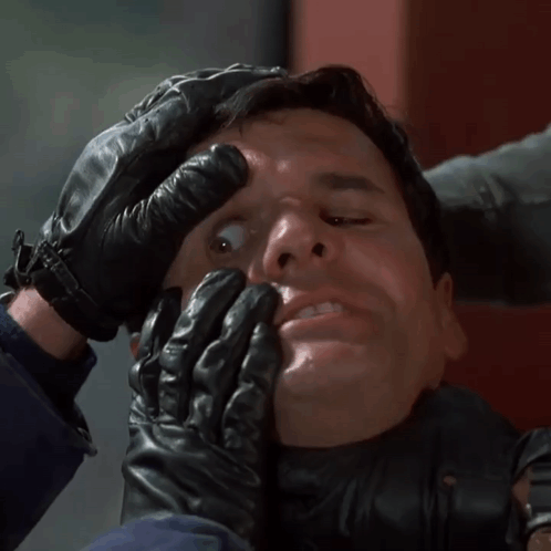 Man in Black Leather Gloves Held by Another