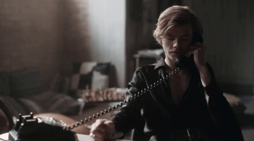 Man in Black Leather Jacket Talking on Phone