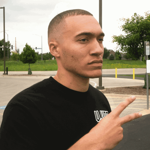 Man in Black Lollipop Shirt Giving Peace Sign