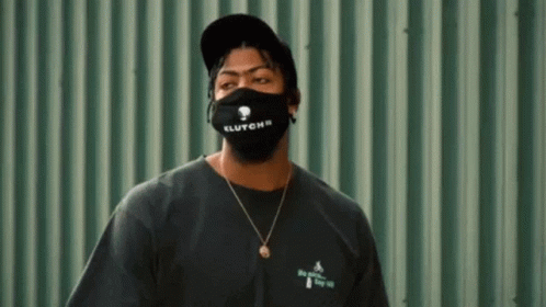 Man In Black Mask And Hat On Green Wall GIF