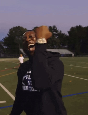 Man in Black NFL Shirt Fist Pump