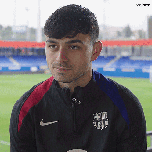 Man in Black Nike Jacket With FCB Logo