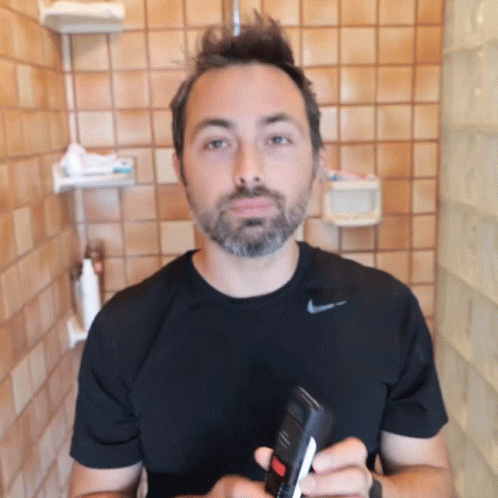 Man in Black Nike Shirt Holding Bottle
