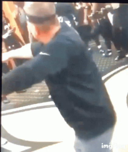 Man in Black Nike Shirt Standing Before Crowd