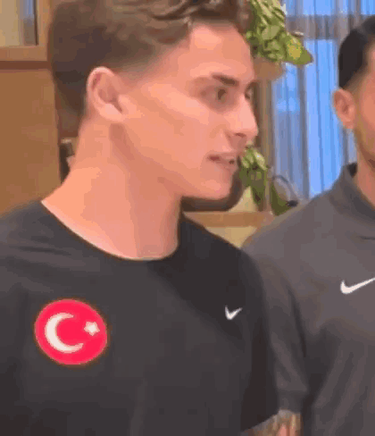 Man in Black Nike T-Shirt With Red Star and Crescent Moon