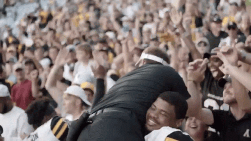 Man in Black Number 3 Jersey Hugging Another Man in Stadium