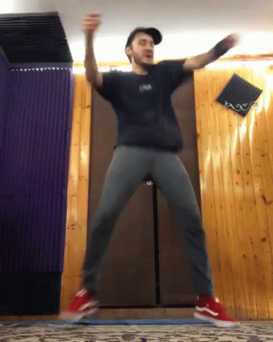 Man In Black Oasis Shirt Jumping GIF