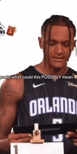 Man In Black Orlando Jersey Holding Paper GIF