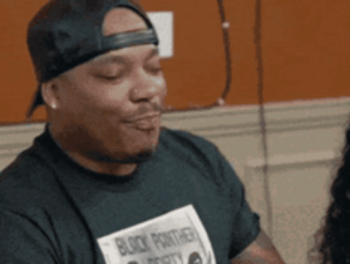 Man in Black Panther Shirt Making a Face