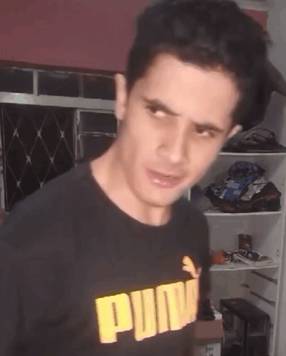 Man in Black Puma Shirt Making Face