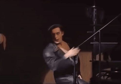 Man in Black Robe Dancing on Stage