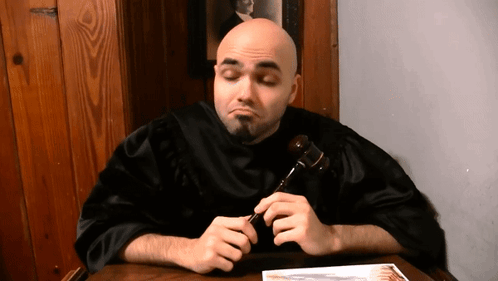 Man in Black Robe Holding Gavel